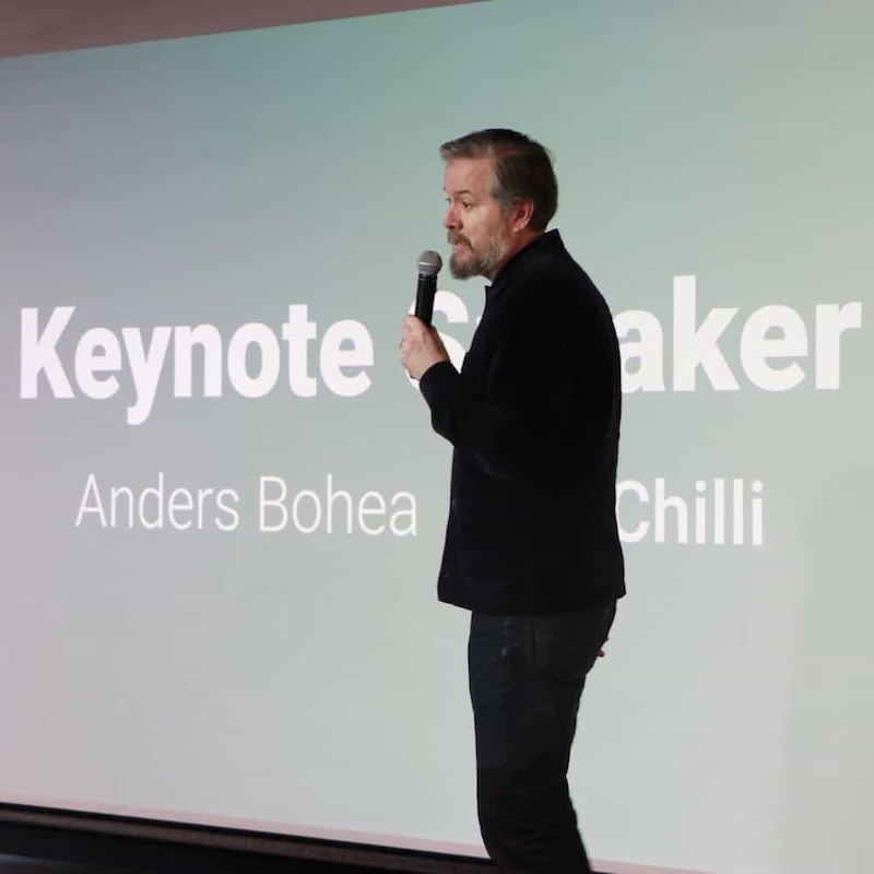 Anders Bohea, Founder of Boxchilli standing on stage with a microphone